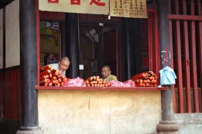 monks selling incense at temple.jpg