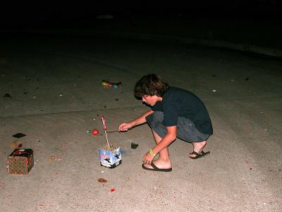 Tyler  lighting a bottle rocket