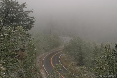 A mountain road in fog.