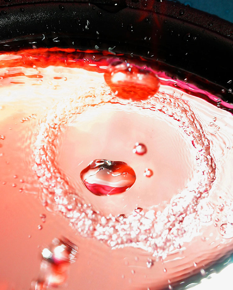 Waterdrop smashes against mirror.