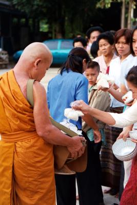 Alms giving to a monk on Buddha day; three bags of rice for good luck, Ban On Luai