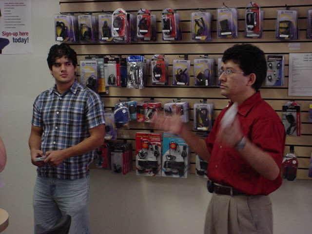 Julio explaining Direct <br> TV DVR to a customer