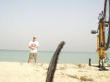 Me at the Persian gulf, with baseball cap and Laos shirt -- and some piece of my shoe