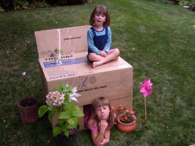 Bri and Hanna with their new house in the backyard at 1140 Woodside