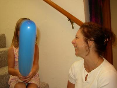 Brianna blows up the balloon....