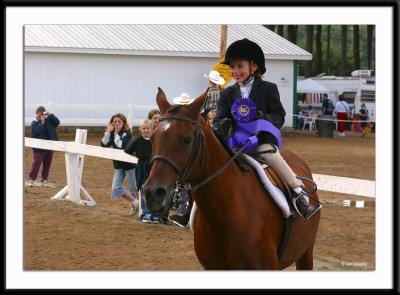 This little sweetheart was one of the junior equestrian champions taking a victory lap in the equestrian center.