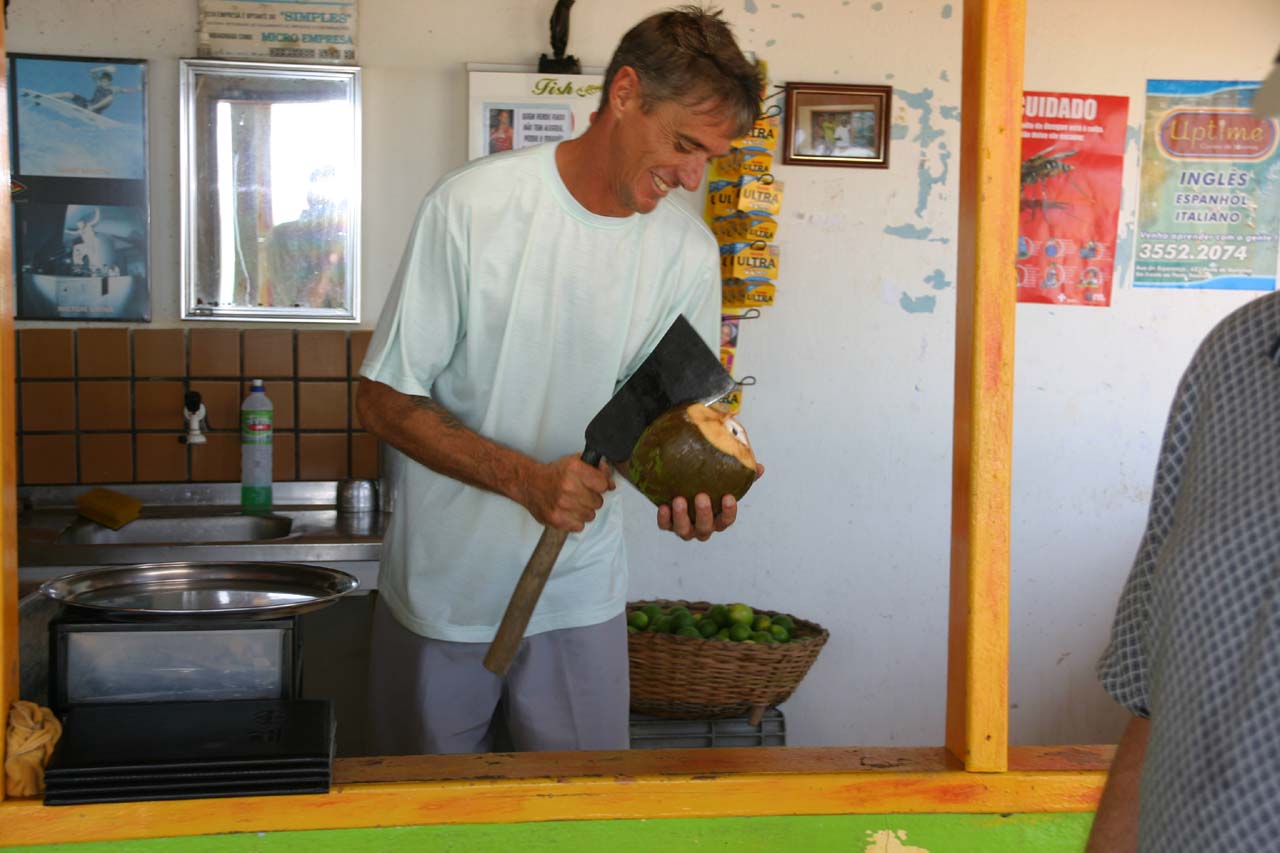 Chopping top off coconut for straw so we can enjoy cold coconut water