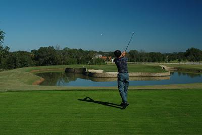 Eric sends a shot to the upper level of an island green at Lantana