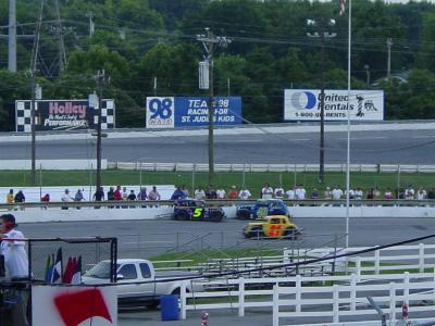 Legend cars tangle on back stretch