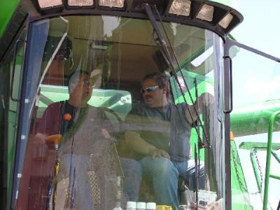 Showing Dr. Rob what it's like to operate a combine.JPG