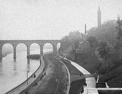 Looking South onto the Harlem Speedway from the Washington Bridge at 181st Street. note Highbridge water tower standing on the hill at the right...Early 1900's.  Now we can see that driveway across the promenade sweeping south and up the hill to that house on the western slope.