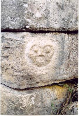 Beautiful human face carved in a corner stone