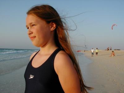 Aven on the beach.  Note the kitesurfing behind her -- my next hobby!