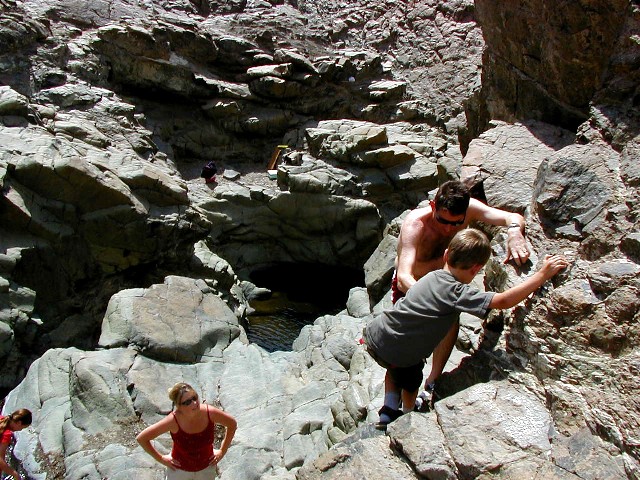 Garnet gets help going down the cliff to the pools.