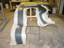 The roof panel just out of the mold untrimmed Kevin promisses that the fiberglass is no more than 2mm thick.