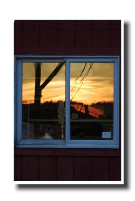 Boothbay is:  A sunset reflected in a lobster shed's window.