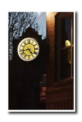 A clock in the middle of town at dusk.....
