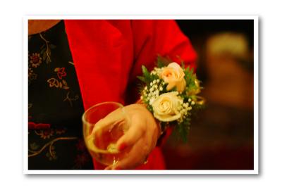 A corsage,  a glass of wine,...