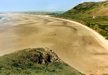 Wales: Rhossili Bay - the easternmost point on the Gower Peninsula. Little dots are people on the beach.