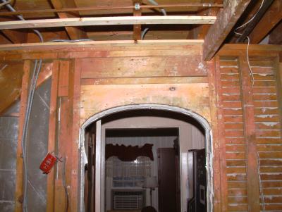 View of existing framing of arched passageway to refridgerator nook and Living Room.