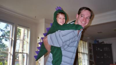 Ben (in his dinosaur costume) on Papa's back (Grandpa and Grandma's house in Norfolk, VA)