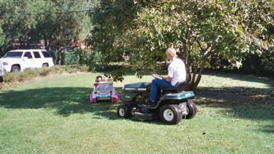 Ben driving the toy Jeep and being chased by Uncle Jeffrey on the lawn mower (Great Grandparents' house in Norfolk, VA)
