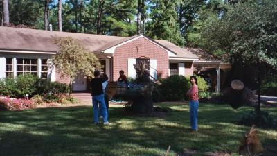 Grandma, Grandpa, Ben, and Mama looking at one of the trees that fell over in the front yard (Grandpa and Grandma's house in Norfolk, VA)