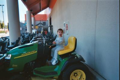 Ben riding the lawn mower on a visit to Home Depot