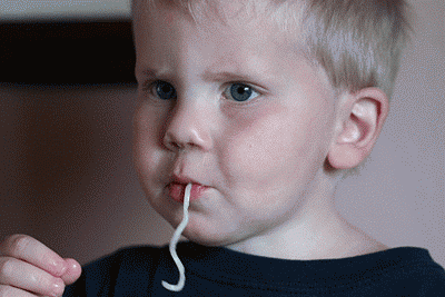 Learning to Slurp!
Ethan figured out how to slurp spaghetti for the first time today!  We celebrated his new talent by making chocolate chip cookies!  Aren't stay-at-home Dads great!  I love the way it looks like he is snapping his fingers!  I don't remember any music playing during lunch!