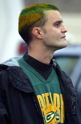 This Greenbay Packer Football fan has a color-coordinated jersey and hair.