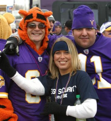 I don't know what a tiger has to do with the Viking Football team, but he is staying warm (and women are hanging out with him).