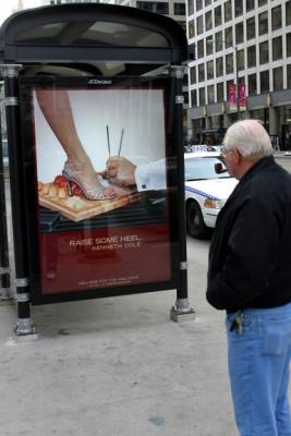 Checking out the sushi on a bus stop ad in Chicago