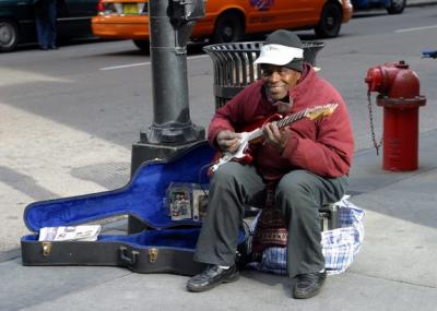 Playing guitar under the L in Chicago