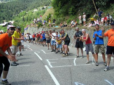 Spectators line the road