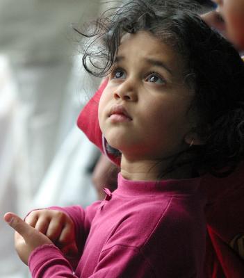 Little girl watching busker