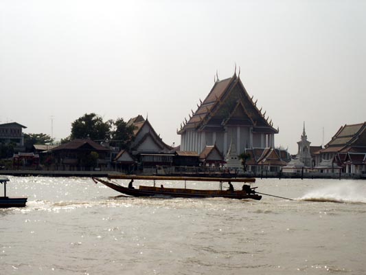 Long-tailed boat and Wat Kalayanamit, Bangkok