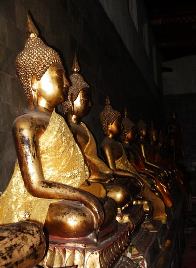 A long gallery of golden Buddhas, Wat Pho, Bangkok