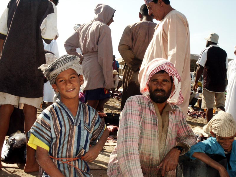 Omani boy with father, Barka fish market