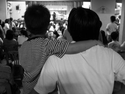 Father and son at a outdoor concert.