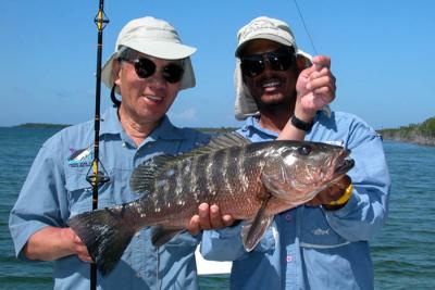 My guide Dubs with a cubera snapper in Belize