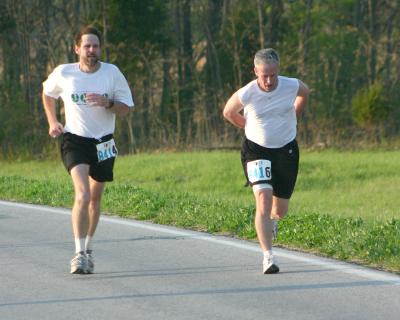 Greg running end of 22nd leg w/Dave (pulling baton out of his pants!)