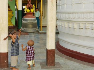 Children hitting one of many bells in Shwedagon