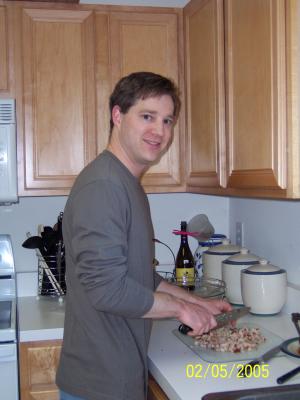 John chopping pork to make his BBQ for the annual Super Bowl Party