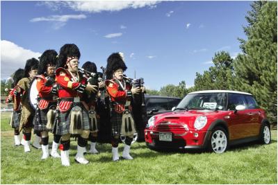 Bagpipers sweep pass an equally colorful MINI.