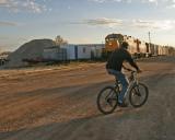 Two trains and a bicycle on and alongside Revillon Road North,Moosonee