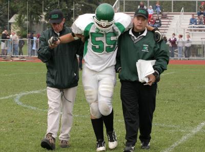 Dan Barta being helped to the sideline