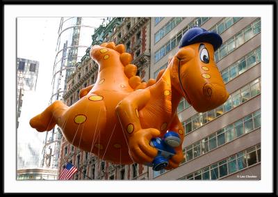 Cheeseasaurus, flashing his disposable camera at the crowds below. The chanting of Cheese, cheese, cheese! welcomed him to Broadway.