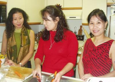 June & Sheri Yi watch Satoko cook