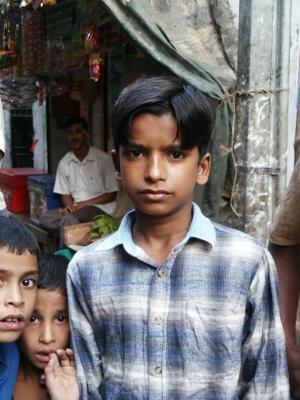 Serious boy with 2 young children, Dhaka, Bangladesh