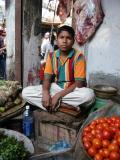 Boy working at produce stand, Dhaka